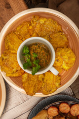Delicious patacones freshly removed from the oil, showing off their crispy exterior and soft green plantain interior