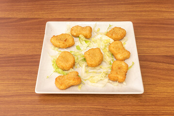 Southern-style fried chicken nuggets, with their thick and spicy breading, served with jalapeño sauce