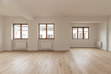 Voluminous loft-style living room with an exposed steel structure, polished concrete walls, and...