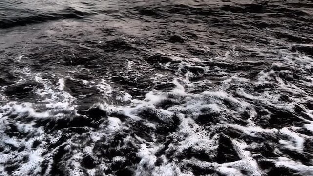 Morning light illuminates the serene scene as gentle waves roll onto the sandy beach at Canj, located along Montenegro stunning Mediterranean coast. The calm water invites relaxation and peace