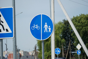 Traffic sign indicating bike lane and pedestrian area in urban setting, encouraging safe travel for...