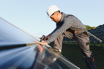 Worker installing solar panels outdoors