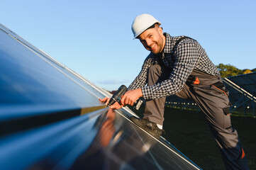 Worker installing solar panels outdoors