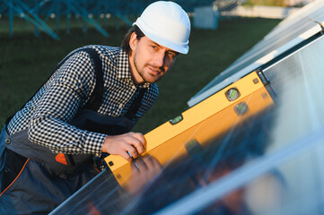 Worker installing solar panels outdoors