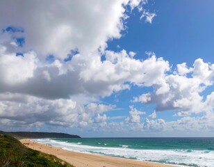 Wide beach view under a partly cloudy sky