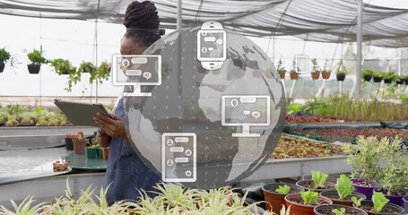 Greenhouse worker tapping tablet reviewing plant data starting transparent globe animating icons - Powered by Adobe