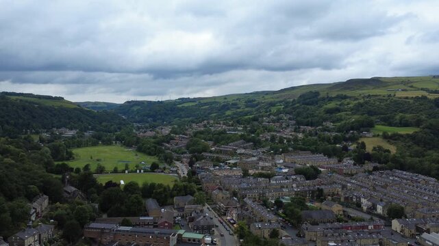 aerial view of the town of Todmorden in West Yorkshire showing the streets public park and surrounding hills