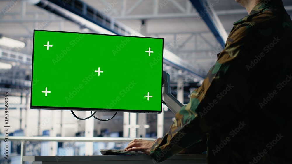 Poster army programmer in server hub uses ai application on green screen mockup pc to review reconnaissance
