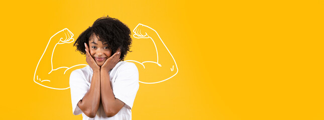 A joyful African American lady expresses strength and confidence against a bright yellow...