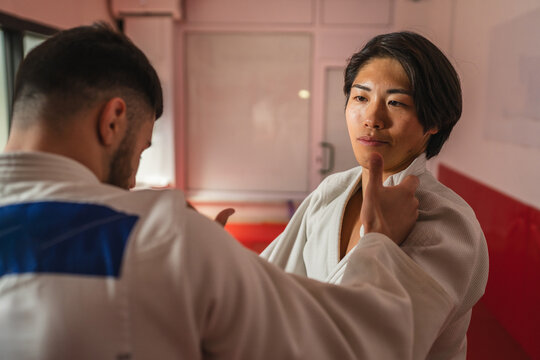 Judo athletes training together in a modern dojo