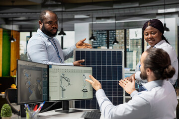 Engineering team doing brainstorming to optimize sustainable solar panel fabrication with advanced...