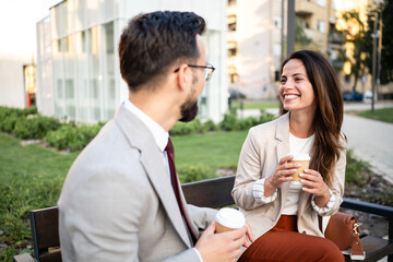 Business people talking and drinking coffee outdoors