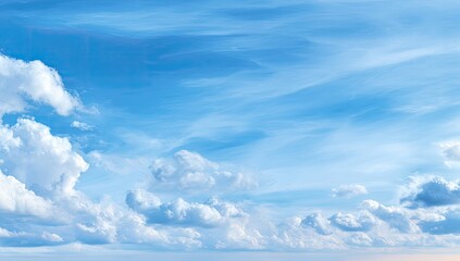Fototapeta premium Wide shot of a vibrant blue sky, dotted with fluffy white clouds