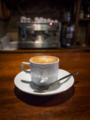 Hot coffee served in front of a professional espresso machine