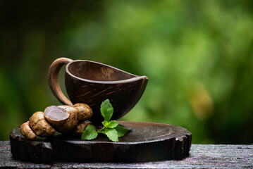 Black ginger is brewed into tea and sweetened with stevia on natural background.