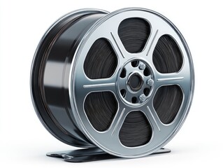 Obraz premium A metallic reel, polished to a high sheen, showcasing a coiled, dark-toned strip, rests on a stand against a white background.