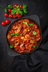 Traditional artisan homemade gambas prawn und fish stew romesco de peix in cast-iron skillet
