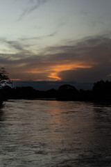 Naklejka premium Sunset on the river in the tropics. Beautiful landscape.