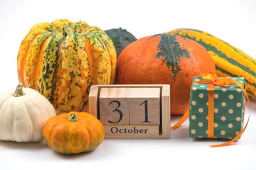 alloween Pumpkins with Wooden Blocks 31 October and Green Gift Box on White Background