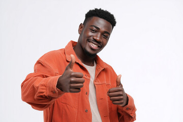 Young african american man in orange jacket smiling and showing double thumbs up on isolated transparent PNG background for cutout projects
