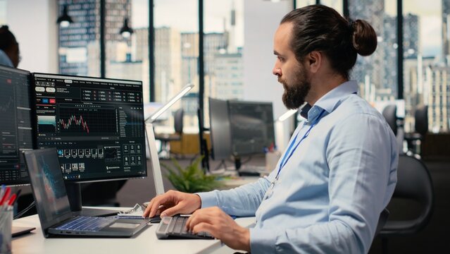 Trader in office leverages artificial intelligence on laptop to interpret charts, optimizing buying and selling. Stockbroker uses deep learning automatization on notebook to maximize profits