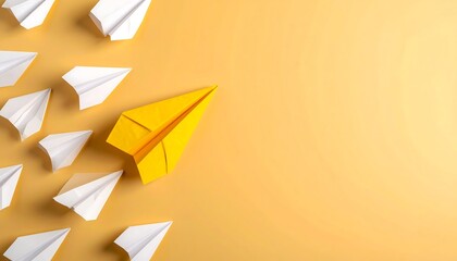 A yellow paper airplane stands out among many white ones