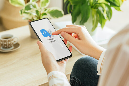 Woman using google translate app on smartphone at home