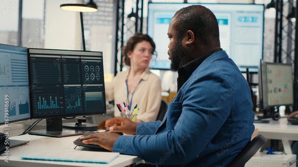 Poster black male administrator in modern workspace analyzing forecast insights and business strategy on a 