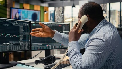 Distressed brokerage firm trader making phone calls to clients in response to Black Swan event...