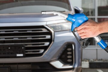 Human hand refuel the car with petrol