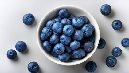 fresh ripe blueberries in a round white ceramic bowl overhead view