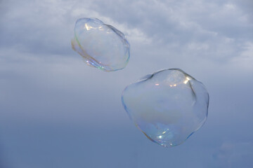Huge bubble with blue sky and white cloud background