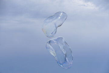 Huge bubble with blue sky and white cloud background