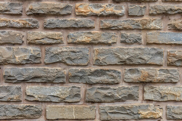 Rustic stone brick wall background with rough textured surface