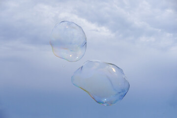 Huge bubble with blue sky and white cloud background