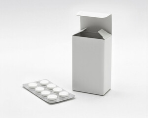 White medicine box open with blister pack outside on white background