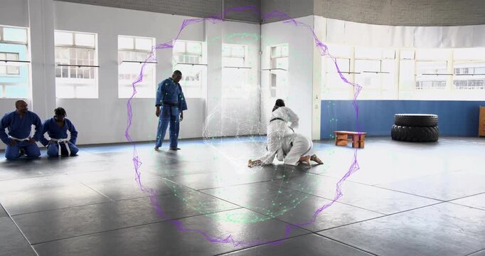 Holographic ring appearing for jiu-jitsu drill as black-belt girl executing takedown and sparring