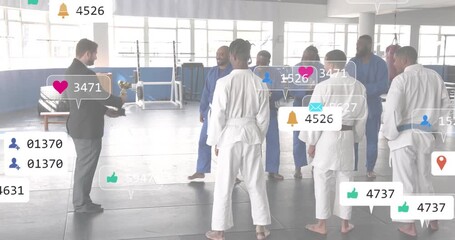 Man in suit raising arm and offering trophy for martial arts achievement, digital icons increasing - Powered by Adobe