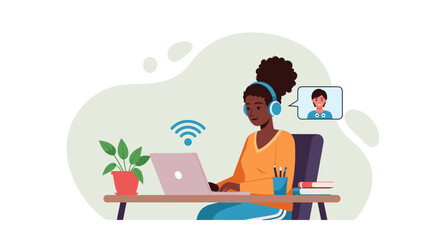 African American woman in headphones working on laptop, video calling from home office. Represents remote work, online learning, and digital communication.