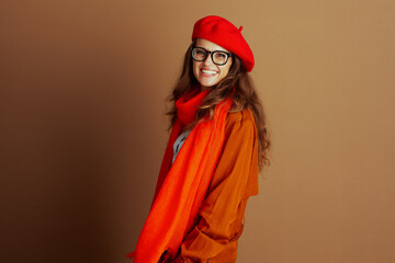 A stylish young woman with black-rimmed glasses, a red beret, and a vibrant red scarf, wears an...