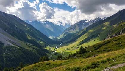 A sweeping vista of a verdant mountain valley, bathed in sunlight, with snow-capped peaks piercing the cloudy sky.