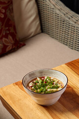 Indulge in a Delicious Bowl of Soup, enhanced with Fresh Herbs and an array of Spices