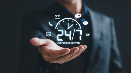24/7 customer service support concept with businessperson holding digital icon, communication symbol, and clock, representing reliable assistance and professional help anytime