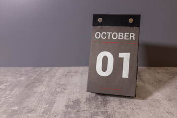 October 1st. Image of october 1 wooden color calendar on blue background.