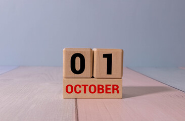 October 1st. Image of october 1 wooden color calendar on blue background.