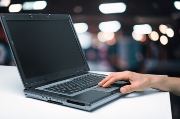 Person hands typing on laptop computer in office