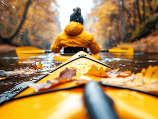 Autumn Kayaking: Person Paddling Yellow Kayak on a River, Rain and Falling Leaves