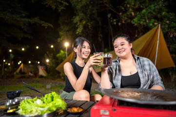 Indonesian southeast asian women relaxing together outdoors and enjoying refreshing drinks. The scene of the lifestyle of enjoying food in a natural setting