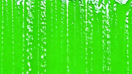 Refreshing water falling against a vibrant green screen for dynamic special effects projects