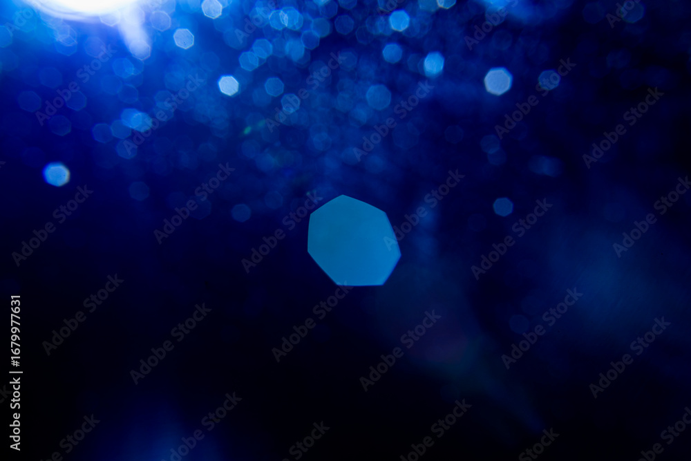 Poster abstract background featuring soft, dark blue bokeh lights. decorative element suitable for use as a